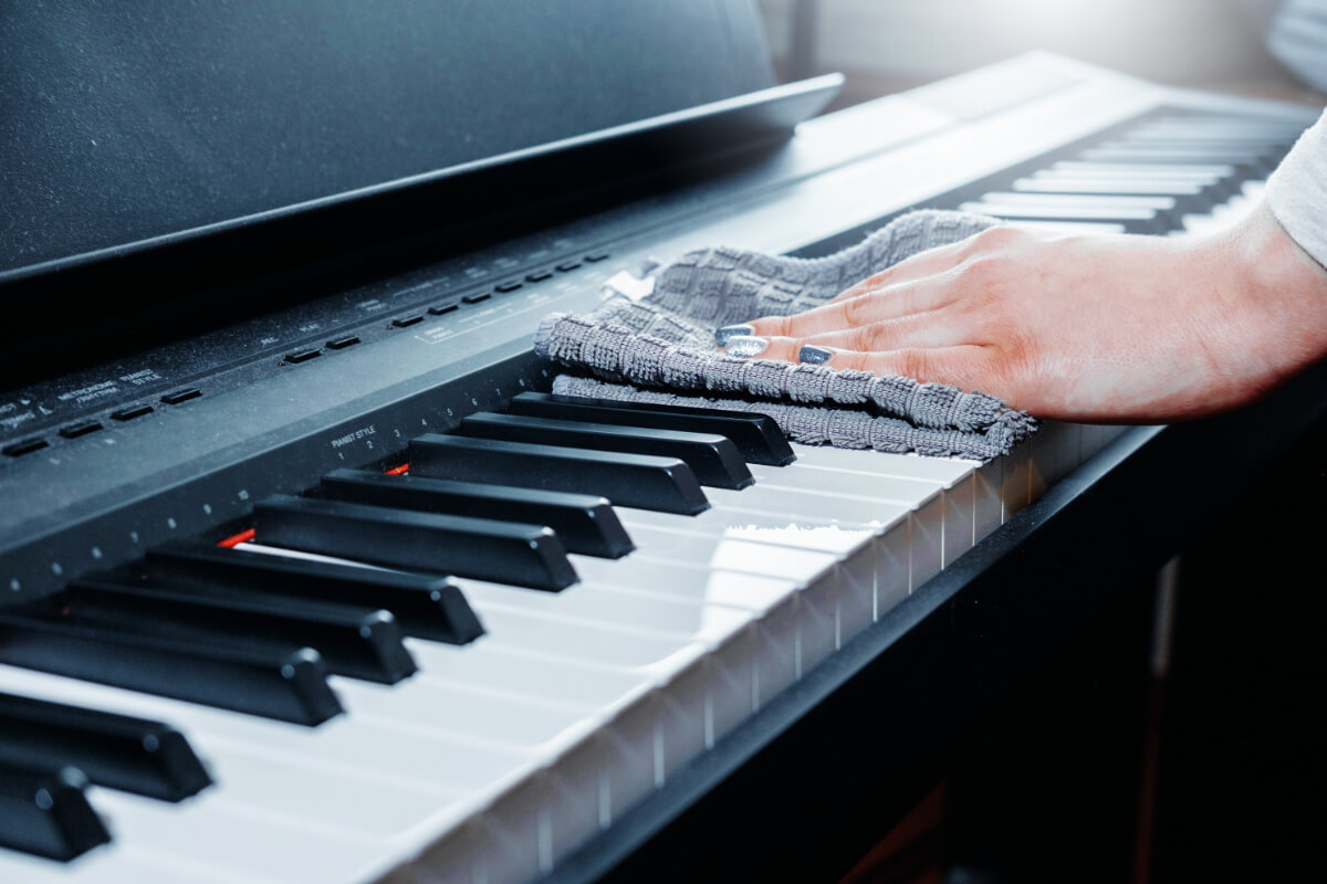 cleaning piano keys and cabinet